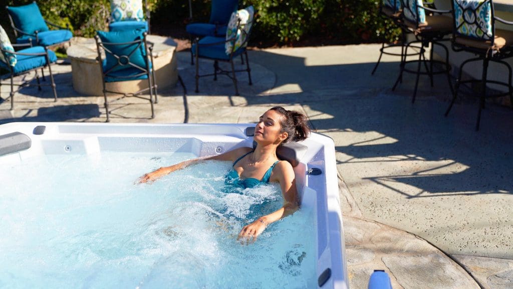 HotSpring Hot Spot 2020 Relay Spa outside in back yard with woman in spa
