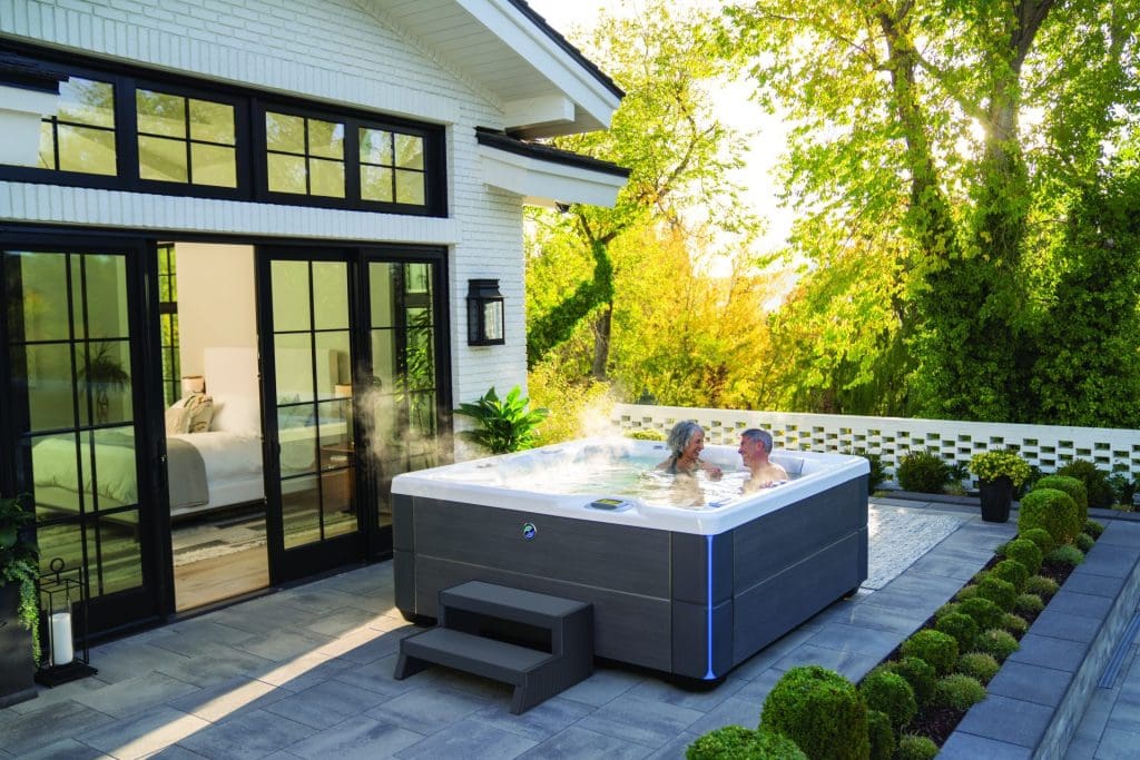 Hot Spring 2023 Highlife Aria Spa outside in backyard with man and woman