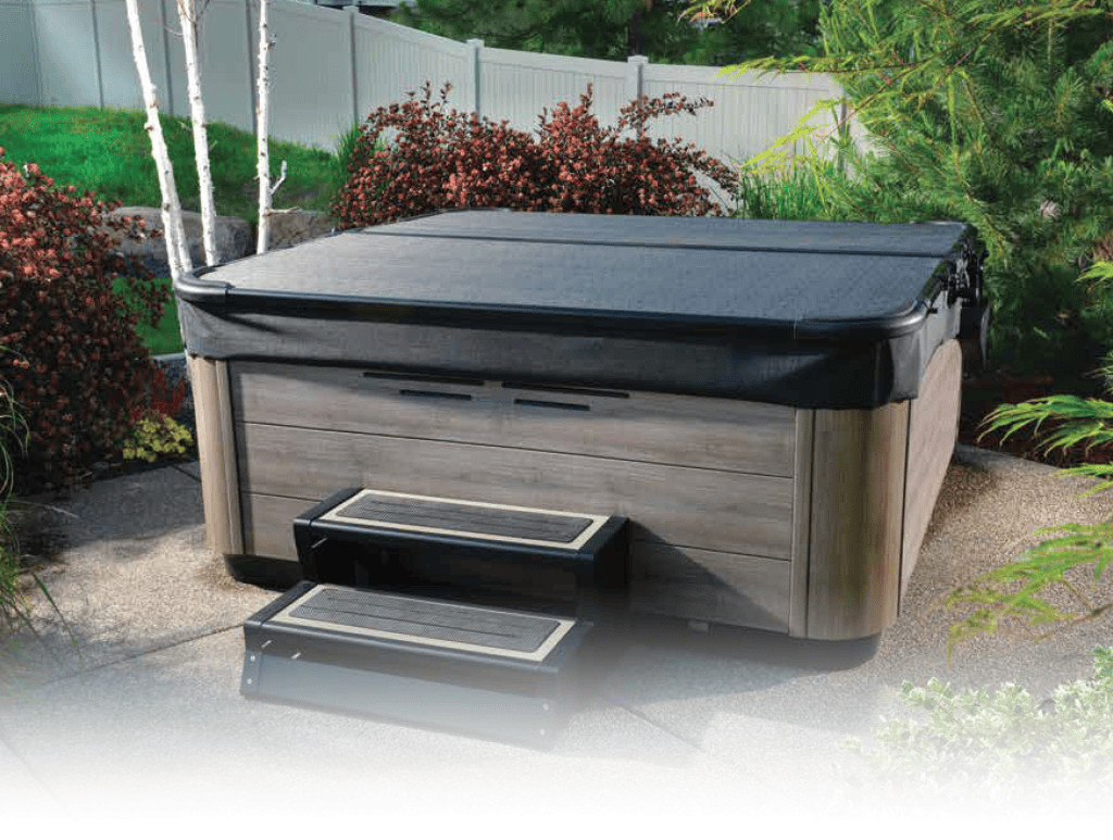 Smartop on a custom built tub in a backyard in front of flowers