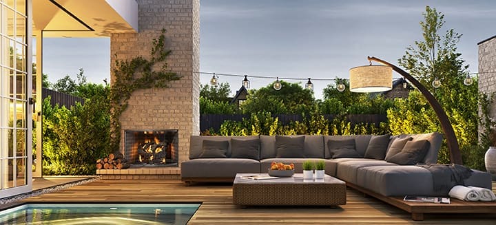 Outdoor living example - fireplace built into the outside wall of a house next to patio furniture