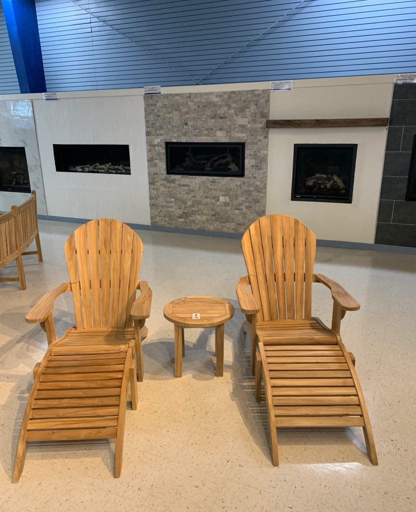 teak furniture in a showroom - two teak chairs and teak table