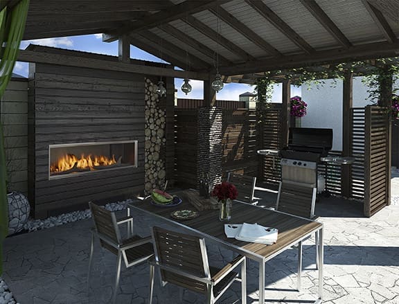 Outdoor living example - fireplace built into the outside wall of a house next to patio furniture and a BBQ