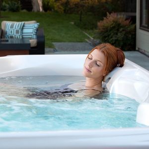 Woman using a hot spot hot tub for hydrotherapy