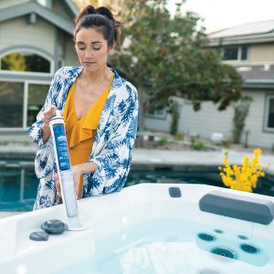 A woman loads sanitizer into a Hot Spot hot tub